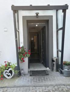 an entrance to a building with two potted plants at Nassauer Hof Wiesbaden-Schierstein in Wiesbaden