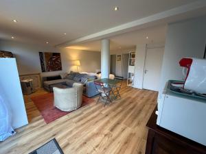 a living room with a couch and a table at Chambre-Studio et SAUNA indépendants in Annecy