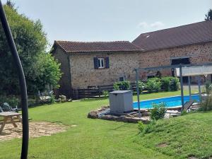 a backyard with a swimming pool and a house at Beautiful 2 bed cottage with swimming pool in Pagéas