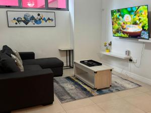 a living room with a couch and a tv at Parkhurst Lux Condo Near Devon House in Kingston +16 photos