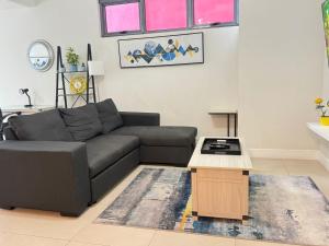a living room with a couch and a table at Parkhurst Lux Condo Near Devon House in Kingston