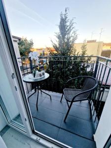 a patio with a table and a chair on a balcony at Angel in Kołobrzeg