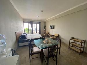 a bedroom with a bed and a table and chairs at Lippo Carita Selatan in Carita