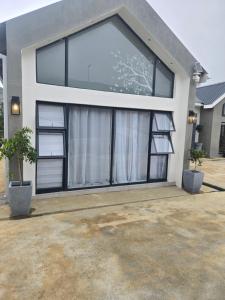 a house with a large window on the front of it at WeThusi stream in Mbabane