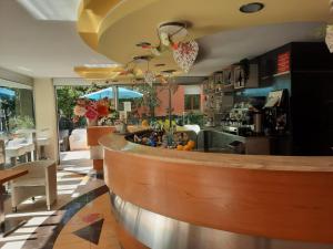 a bar in a restaurant with a counter at Hotel Mirage in Rimini