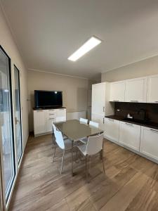 a kitchen with a table and chairs in a room at Antico Pozzo in Badia