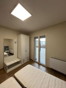 an empty bedroom with a bed and a window at Antico Pozzo in Badia