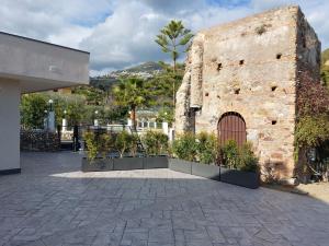 a brick building with a door and some plants at Antico Pozzo in Badia
