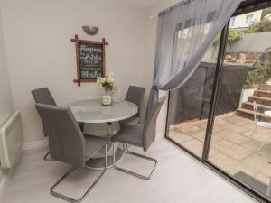 a dining room with a white table and chairs at Castle View in Deganwy +31 photos