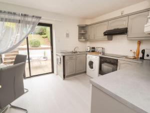a kitchen with a sink and a dishwasher at Castle View in Deganwy