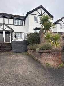a large white house with a gate and a driveway at Castle View in Deganwy