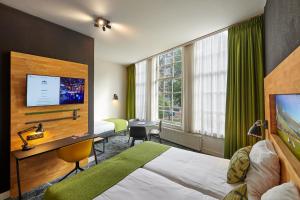 a hotel room with a bed and a desk at Nova Hotel in Amsterdam
