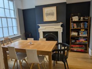 a dining room with a wooden table and chairs at Seaside 4 bed terraced house in Hastings
