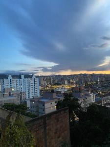 a view of a city at sunset with buildings at Hostel do atleta in Belo Horizonte +31 photos