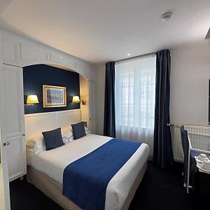 a hotel room with a bed and a window at Austin's Saint Lazare Hotel in Paris +82 photos