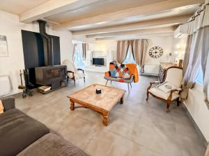 a living room with a couch and a fireplace at Maison 4 ch, véranda, proche commodités, Aurillac in Aurillac