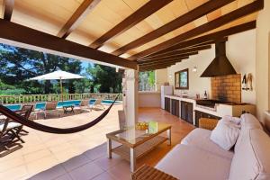 a living room with a couch and a table at Villa Sophia in Port d'Andratx