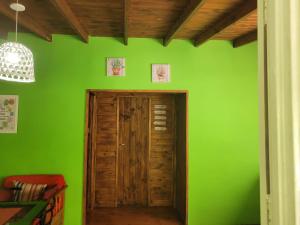 a green wall with a wooden door in a room at Cabaña bruji in Tigre +7 photos