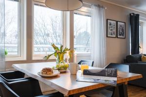 a table with a plate of food on it in a living room at Guestly Homes - Spacious Top Floor 2BR Residence in Luleå