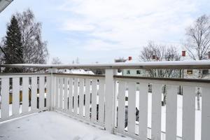 a white balcony with snow on the railing at Guestly Homes - Spacious Top Floor 2BR Residence in Luleå