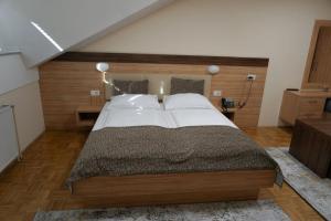a bedroom with a large bed with white pillows at Gostisce Ulipi in Slovenske Konjice