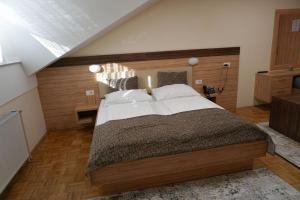 a bedroom with a large bed in a room at Gostisce Ulipi in Slovenske Konjice