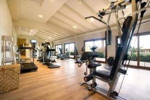 a gym with treadmills and exercise equipment in a room at Hotel Los Ángeles Denia in Denia