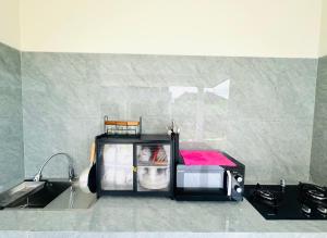 a kitchen with a sink and a counter top at Umah Anami in Jimbaran +3 photos