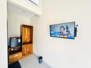 a flat screen tv hanging on a wall at Umah Anami in Jimbaran