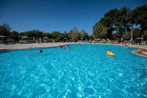 a group of people swimming in a swimming pool at Camping Bi Village - Maeva Vacansoleil in Valbandon