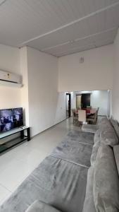 a living room with a couch and a table at JK Casa de Praia in Ilha Comprida