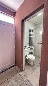 a bathroom with a toilet and a shower at Casa AMBAR in Concordia +21 photos