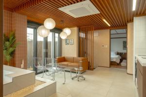 a living room with a glass table and a couch at Staykor Busan in Pusan +69 photos