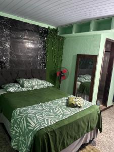 a bedroom with two beds and a mirror at Condo Flat Solar de Aquários in Cabo Frio