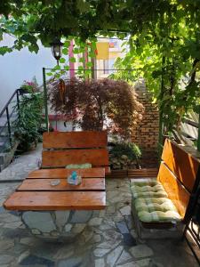 a wooden bench sitting in front of a building at Emmaia Escape Eforie Nord in Eforie Nord