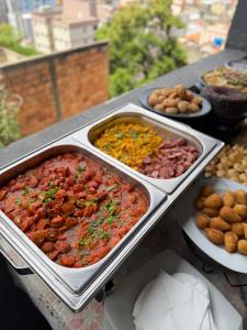 a buffet of different types of food on a table at Hostel do atleta in Belo Horizonte