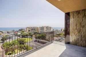 a balcony with a view of a city at Top-Floor Sea View with Pool Access in Catania