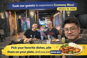 a group of men sitting at a table with a plate of food at Great Shanghai Guesthouse in George Town