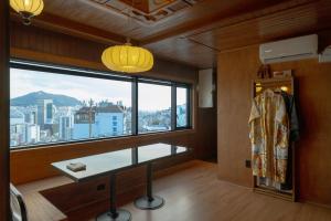 a room with a large window with a view of the city at Staykor Busan in Pusan