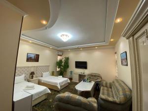 a living room with a bed and a couch at Amina in Samarkand