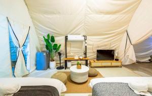 a room with two beds and a tent at kingdom glamping in North Pattaya +4 photos