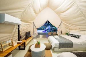 a bedroom with a bed in a tent at kingdom glamping in North Pattaya