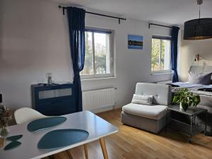 a living room with a couch and a table at Seepavillon Rheinsberg in Rheinsberg