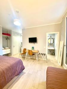 a bedroom with a bed and a dining room at Sunny Beach Bari in Bari