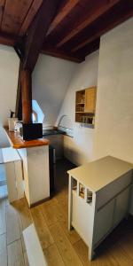a kitchen with a table and a counter top at Appartement château Uriage-Chamrousse in Saint-Martin-dʼUriage