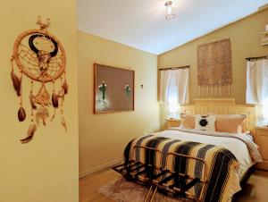 a bedroom with a bed and a dream catcher on the wall at Early Birds in Tucson
