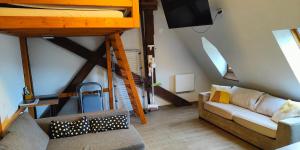 a living room with a couch and a bunk bed at Appartement château Uriage-Chamrousse in Saint-Martin-dʼUriage