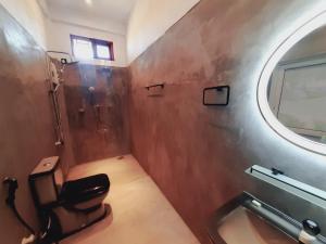 a bathroom with a shower and a sink and a mirror at Drift Bay in Arugam Bay +44 photos