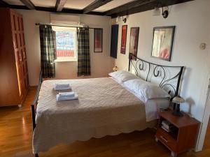 a bedroom with a large bed and a window at Apartments Tedeschi in Korčula