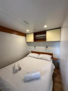 a bedroom with a bed with towels on it at Camping Bi Village - Maeva Vacansoleil in Valbandon +42 photos